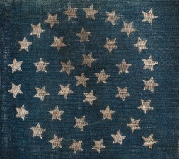 blue section of US flag with 38 stars arranged in a circle.