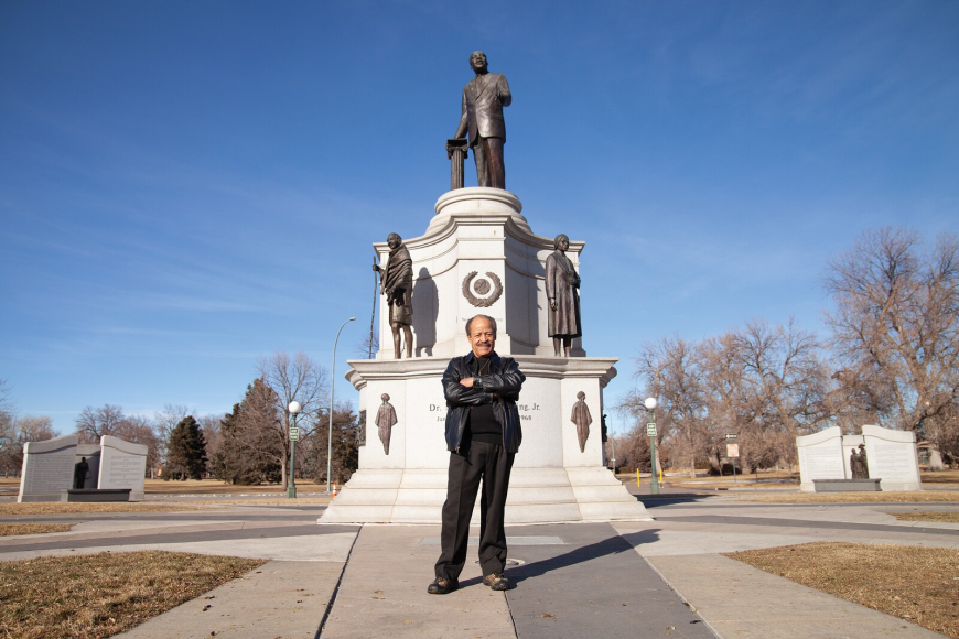 Ed Dwight standing in front of the MLK Memorial he sculpted in Denver.