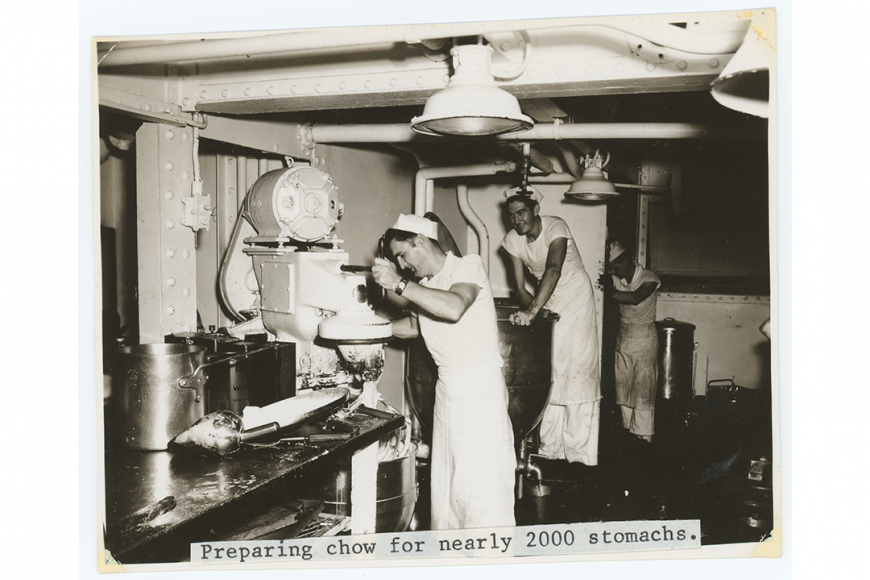 Two chefs use industrial mixers in the USS Colorado kitchen