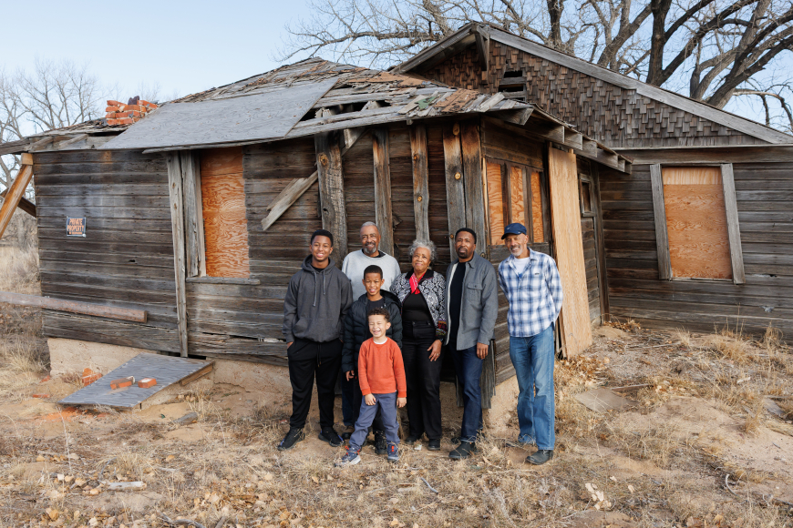 Family in front of Hicks Homestead