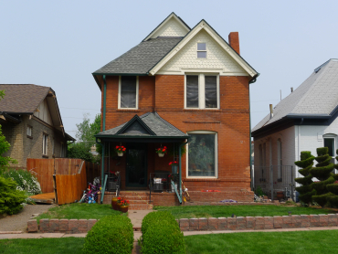 The J. Warner Mills House is a Late Victorian dwelling situated in Denver's Whittier neighborhood. The asymmetrical west side faces Gilpin Street and is divided into two sections. The larger south section is topped by a front-facing gable roof with decorative fish-scale shingles and bargeboards. The smaller north section steps back slightly from the south section and holds the primary entrance. 
