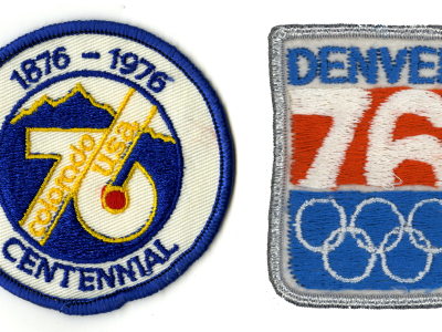 Left, a Colorado Centennial patch from 1976, which reads "76: Colorado, USA. 1876 - 1976 Centennial." Right, a 1976 Denver Olympics patch, made to celebrate games that were never held, which reads "Denver 76" and bears the logo of the Olympic Games.